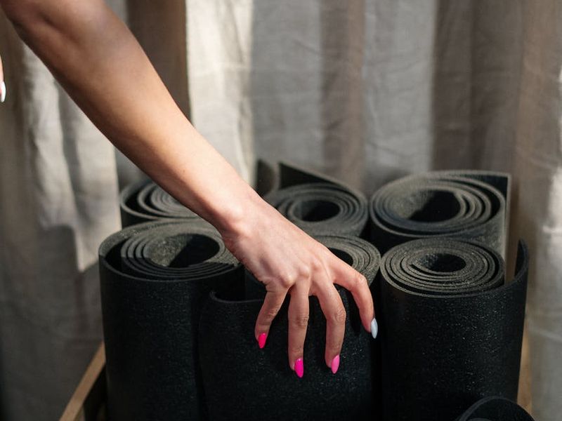 Close up of sports equipment and yoga mat in a clean bright room